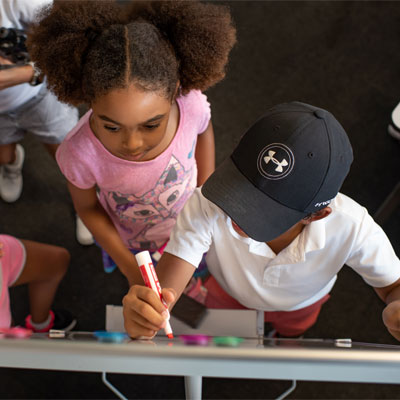 Kids drawing on whiteboard